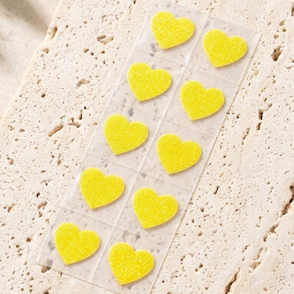 Strip of ten yellow glitter heart test stickers