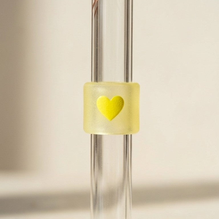 Close-up of the yellow heart test band on the glass straw